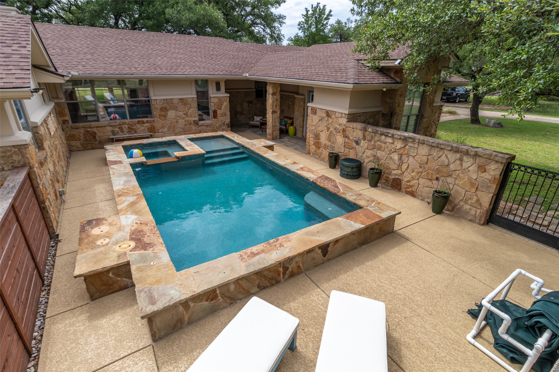 515 E Trail Spicewood, TX 78669 - Photo 29 of 36 a view of a patio with chairs and a table