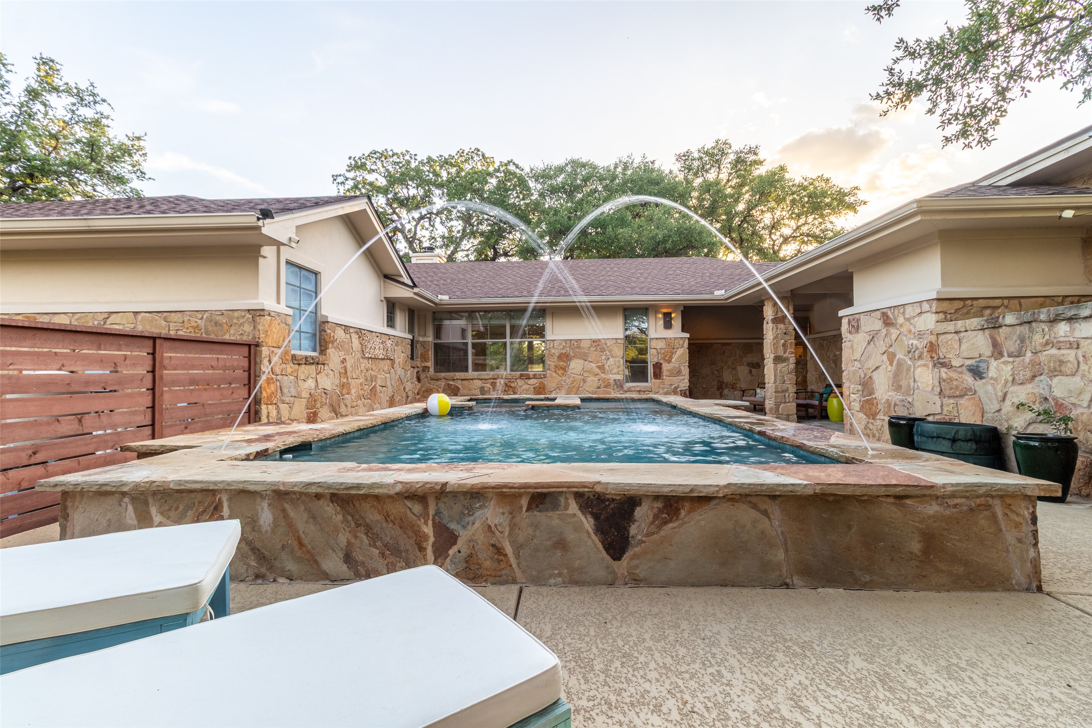 515 E Trail Spicewood, TX 78669 - Photo 6 of 36 a view of a white house with a sink and dining table