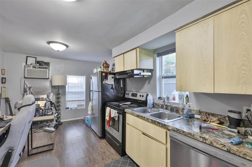 1208 17th Street North St. Petersburg, FL 33713 - Photo 11 of 15 a kitchen with granite countertop a sink stove and cabinets