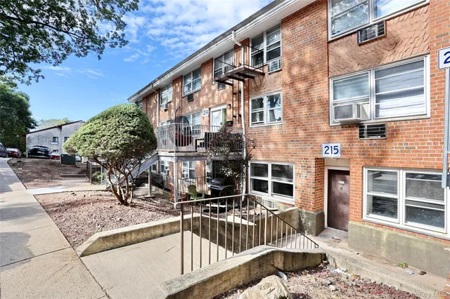 a view of a brick building with many windows