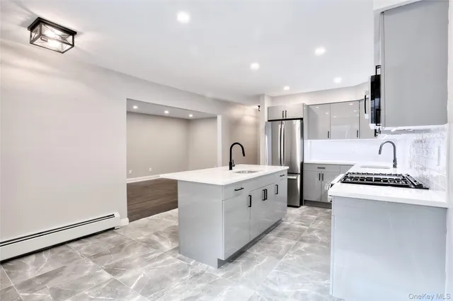 a kitchen with stainless steel appliances a sink stove and cabinets