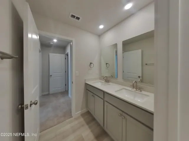 a bathroom with a granite countertop sink mirror and double