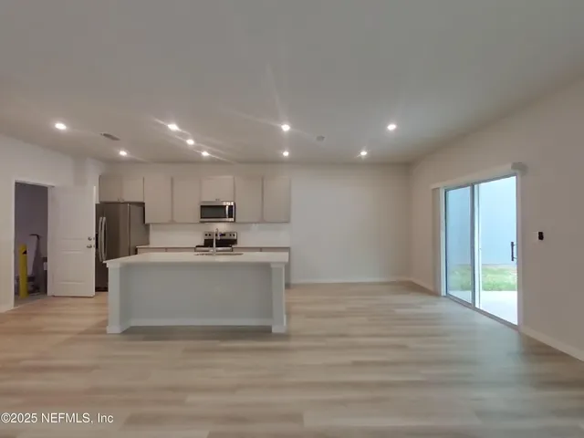 a view of kitchen with granite countertop lots of counter top space