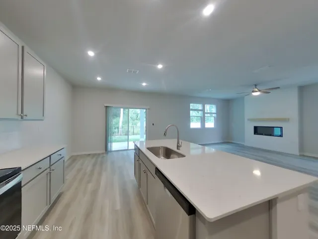 a kitchen with a sink a counter top space and appliances