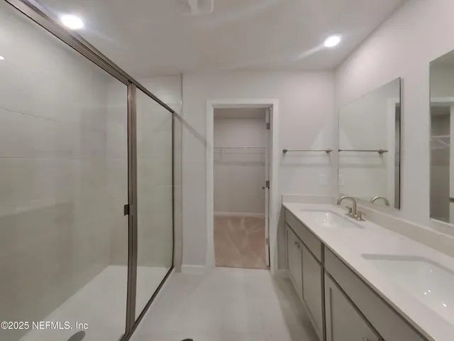 a bathroom with a double vanity sink and mirror