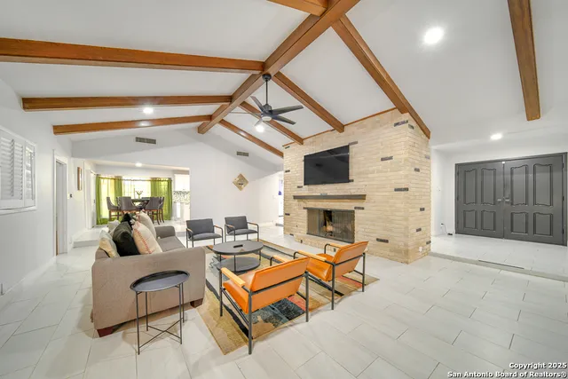 a living room with fireplace furniture and a flat screen tv