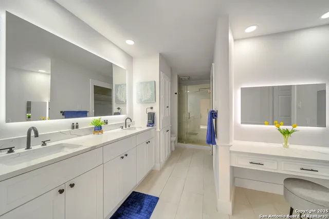 a spacious bathroom with a granite countertop sink and a mirror