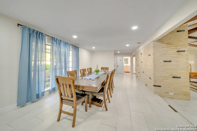 a dining room with furniture and window