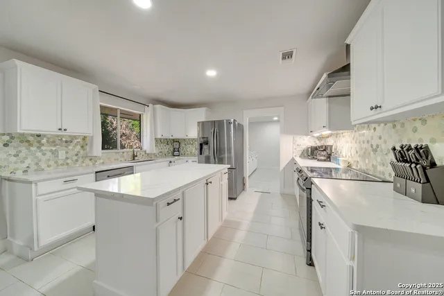 a kitchen with a sink stove and cabinets