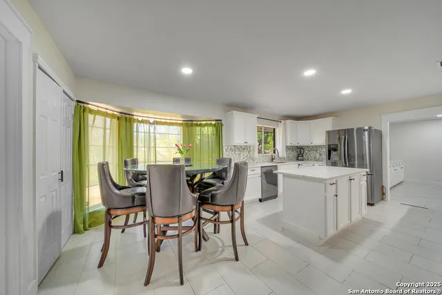 a view of a dining room with furniture and window