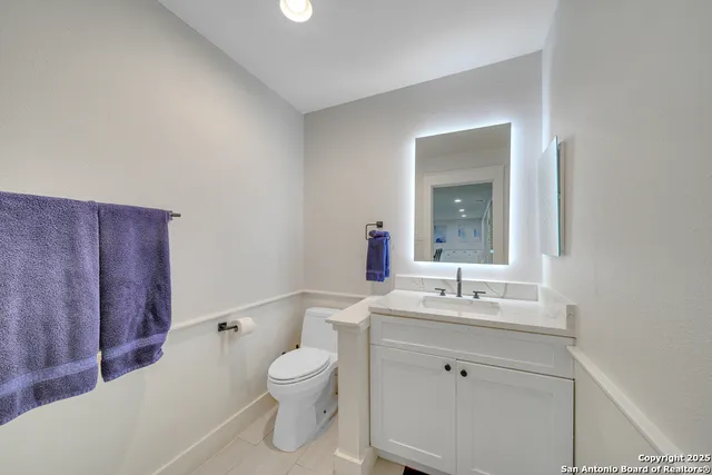 a bathroom with a toilet a sink and mirror