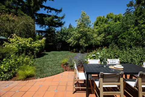 a view of a chairs and table in patio