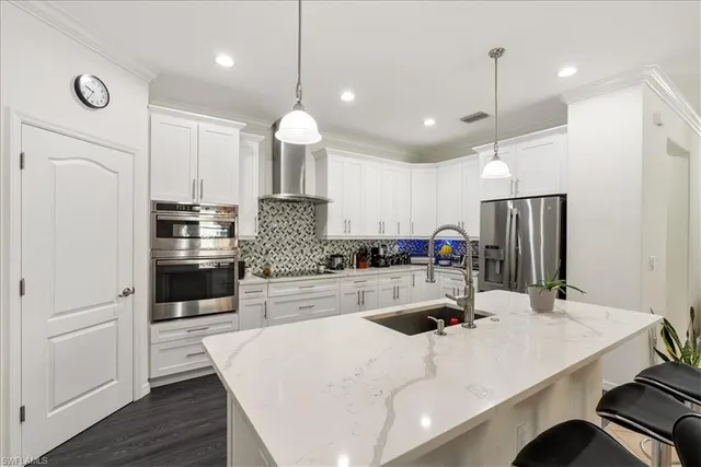 a kitchen with a sink a stove and cabinets