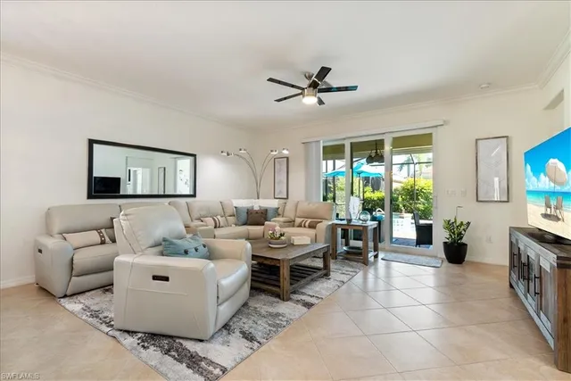 a living room with furniture and a view of kitchen