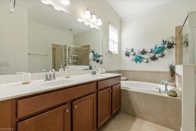 a en suite bathroom with a double vanity sink and a mirror