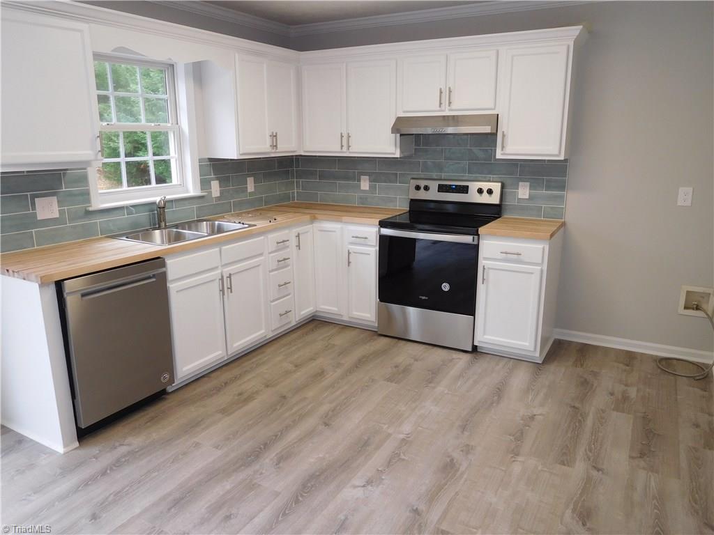 1150 Low Valley Court Rural Hall, NC 27045 - Photo 5 of 15 Spacious Kitchen w/breakfast area. Freshly painted cabinets, new butcher block counters and tile backsplash. All New appliances.