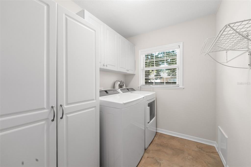 7418 White Oaks Road Alachua, FL 32615 - Photo 37 of 46 a utility room with cabinets washer and dryer