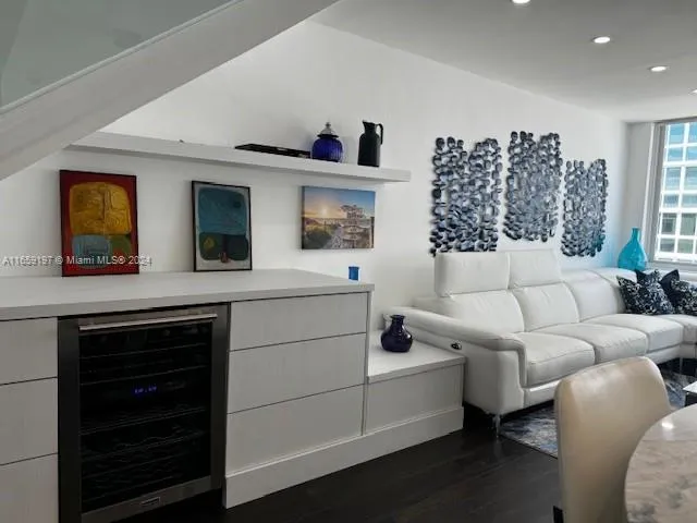 a living room with furniture rug and wooden floor