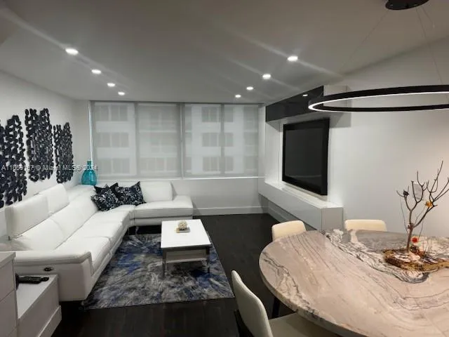 a kitchen with stainless steel appliances granite countertop a sink a microwave a stove and refrigerator