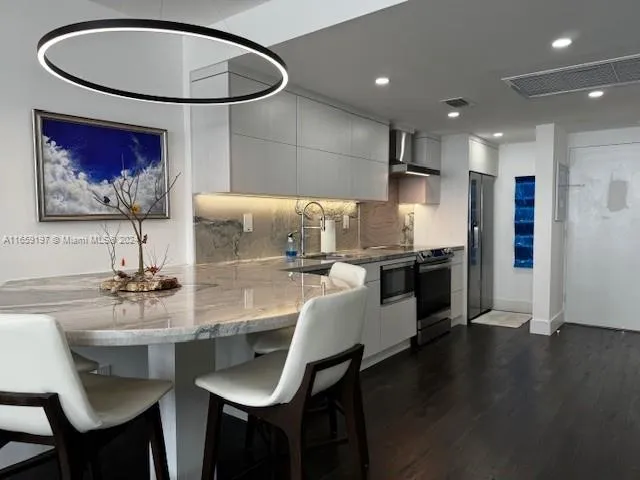 a view of an entryway with wooden floor