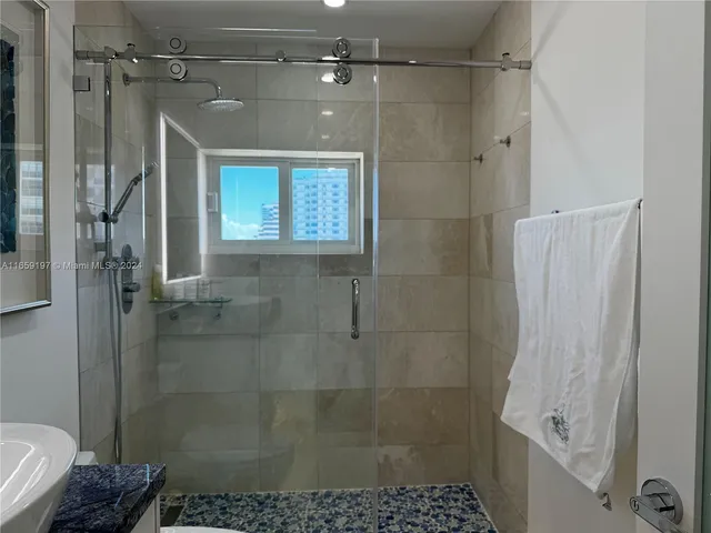 a white toilet sitting next to a bathroom sink