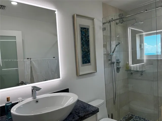 a large bedroom with a bed and cupboard