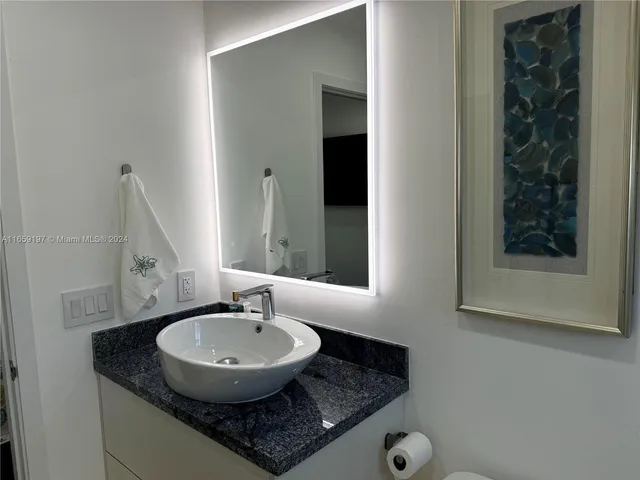 a bedroom with a bed and painting on the wall