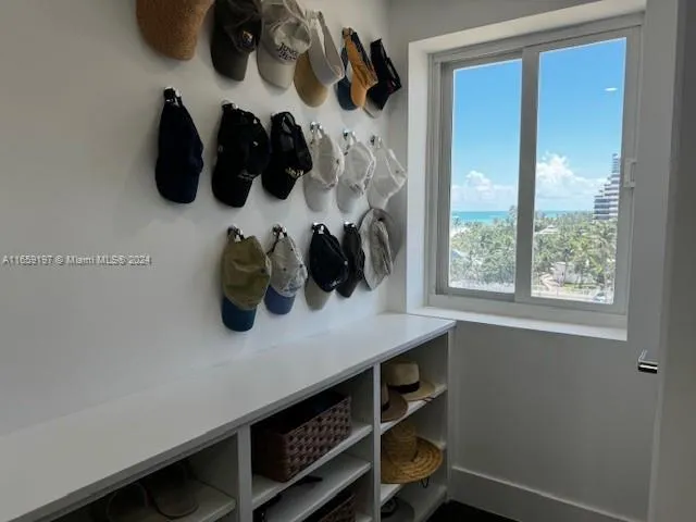 a living room with furniture and a floor to ceiling window