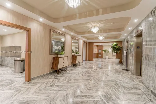 a view of a hallway with wooden floor and a living room