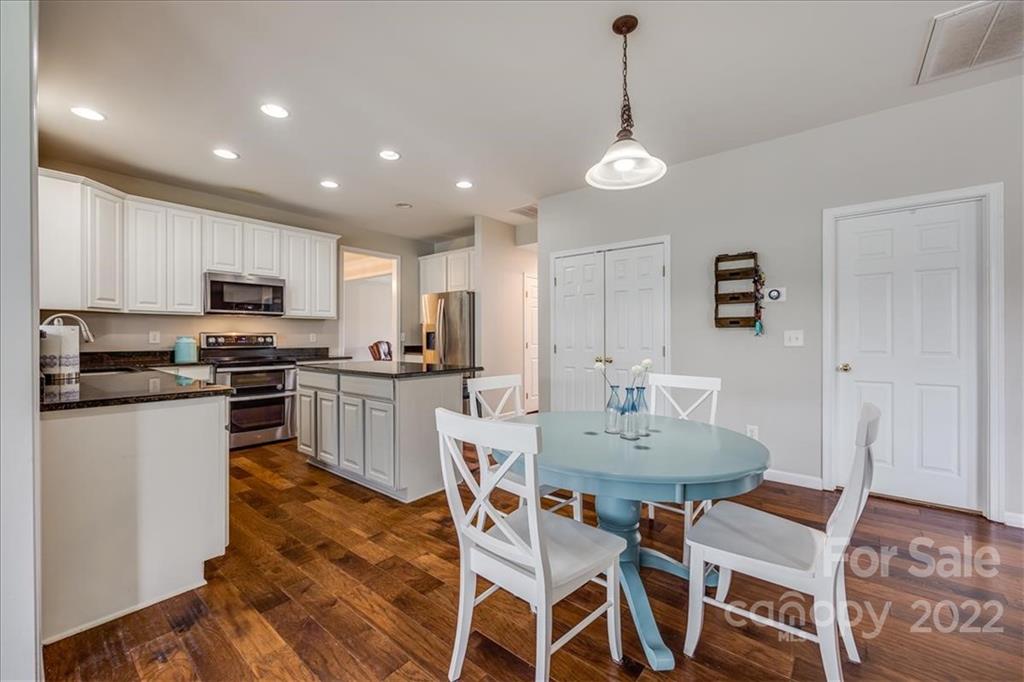 612 Panthers Way Fort Mill, SC 29708 - Photo 11 of 31 a view of a dining room with furniture and wooden floor