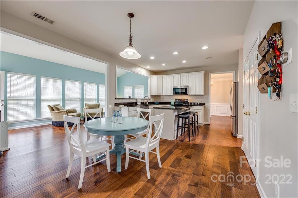 612 Panthers Way Fort Mill, SC 29708 - Photo 12 of 31 a view of a dining room with furniture window and wooden floor