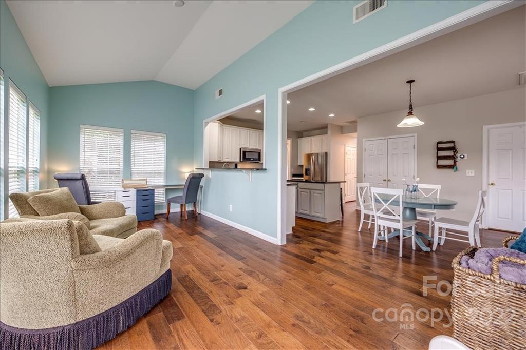 612 Panthers Way Fort Mill, SC 29708 - Photo 13 of 31 a living room with furniture kitchen view and a wooden floor