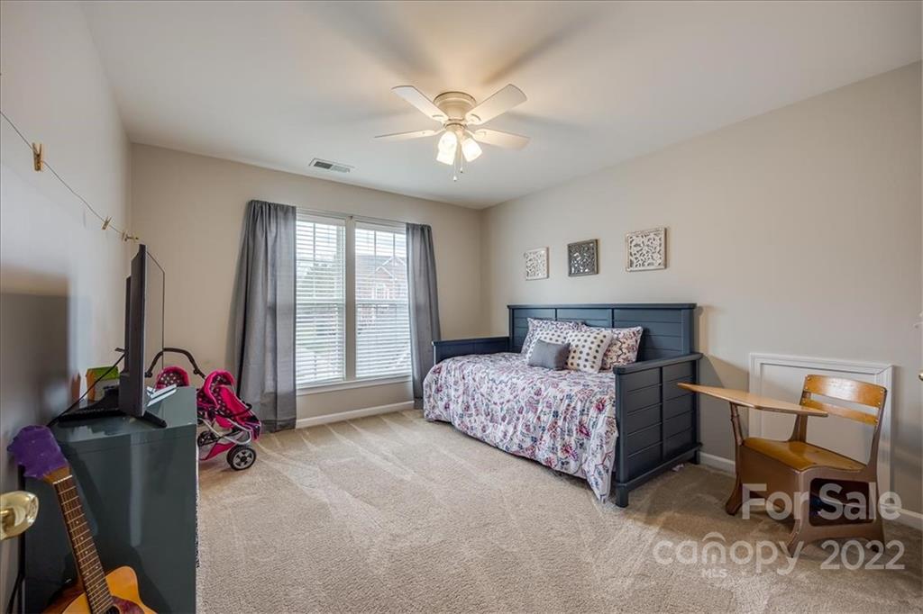 612 Panthers Way Fort Mill, SC 29708 - Photo 20 of 31 a bedroom with bed and a large mirror