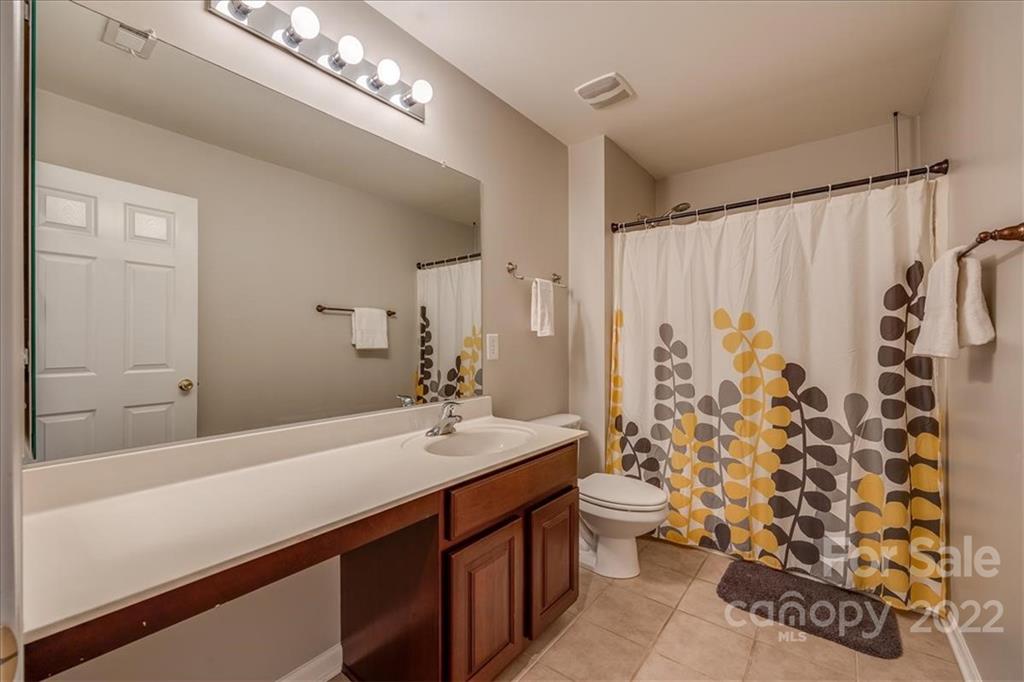 612 Panthers Way Fort Mill, SC 29708 - Photo 21 of 31 a bathroom with a double vanity sink toilet and shower