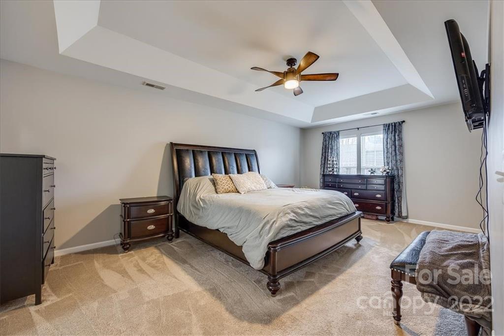612 Panthers Way Fort Mill, SC 29708 - Photo 24 of 31 a bedroom with a bed and wooden floor
