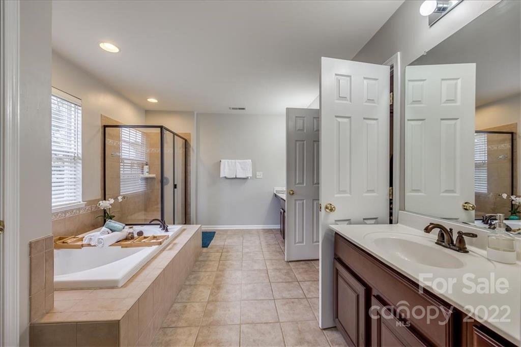 612 Panthers Way Fort Mill, SC 29708 - Photo 27 of 31 a large bathroom with a double vanity sink large mirror and a bathtub