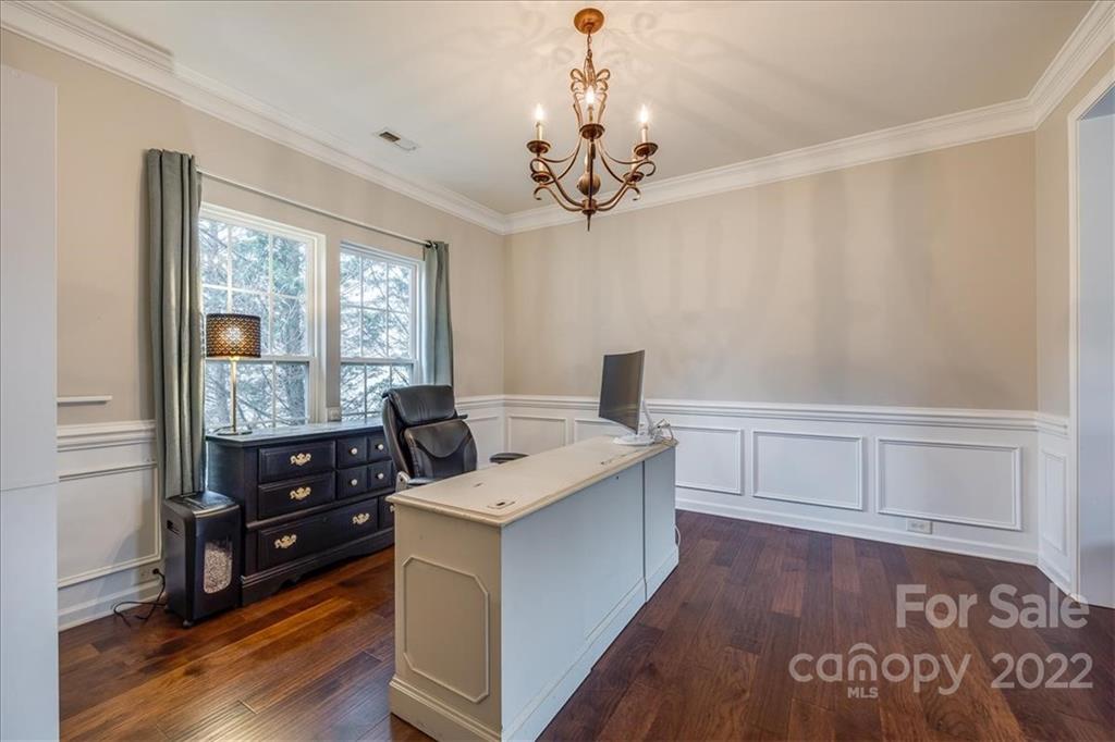 612 Panthers Way Fort Mill, SC 29708 - Photo 7 of 31 a view of a kitchen with a stove wooden floor and windows