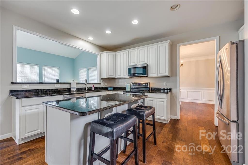 612 Panthers Way Fort Mill, SC 29708 - Photo 9 of 31 a kitchen with a table chairs sink and cabinets