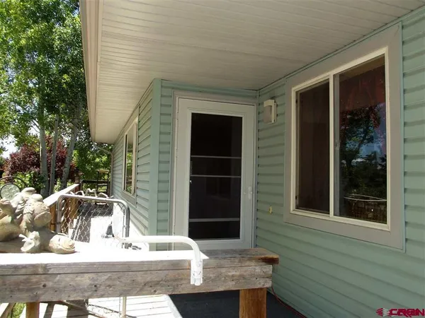 a view of a house with backyard outdoor seating and hardwood