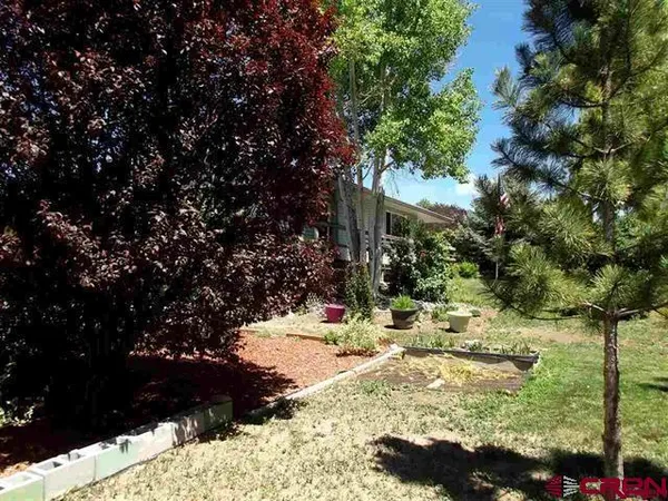 a bedroom with a bed window and wooden floor