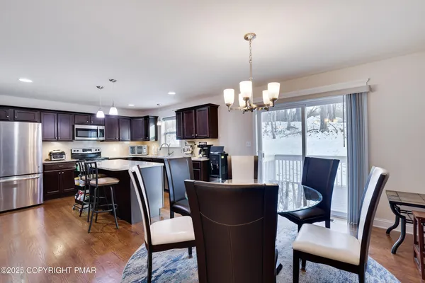 a kitchen with stainless steel appliances granite countertop sink stove refrigerator and cabinets
