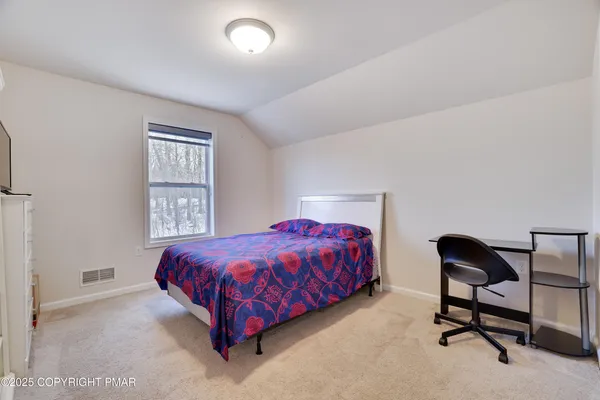 a bedroom with a bed and a chair