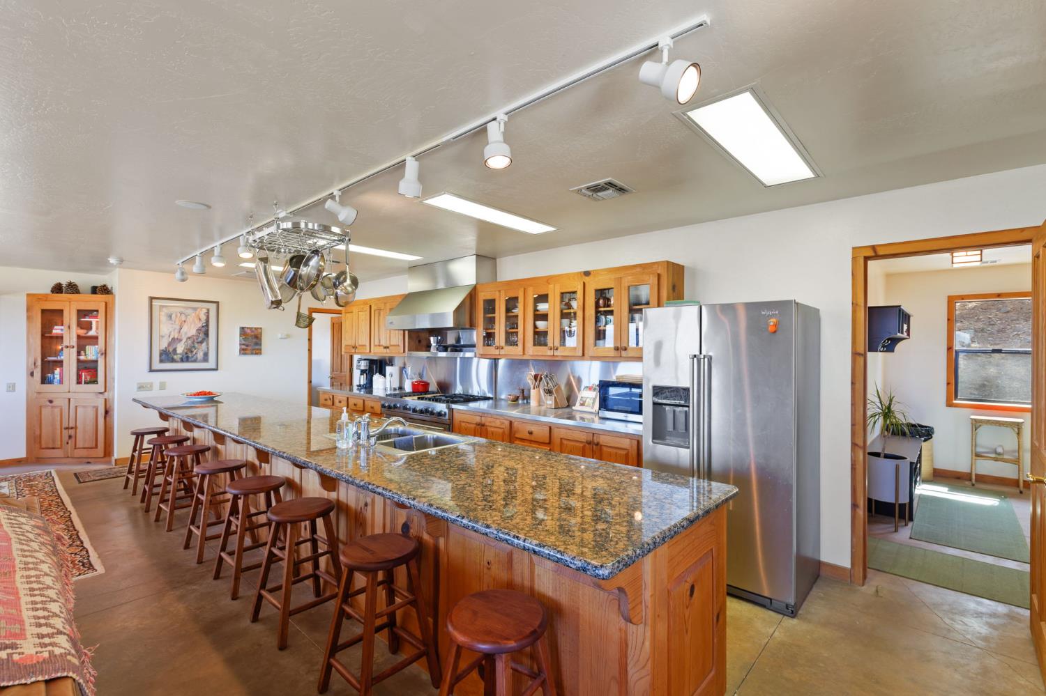 5851 Mt Bullion Ridge Road Mariposa, CA 95338 - Photo 11 of 83 a kitchen with stainless steel appliances granite countertop a table chairs and a refrigerator