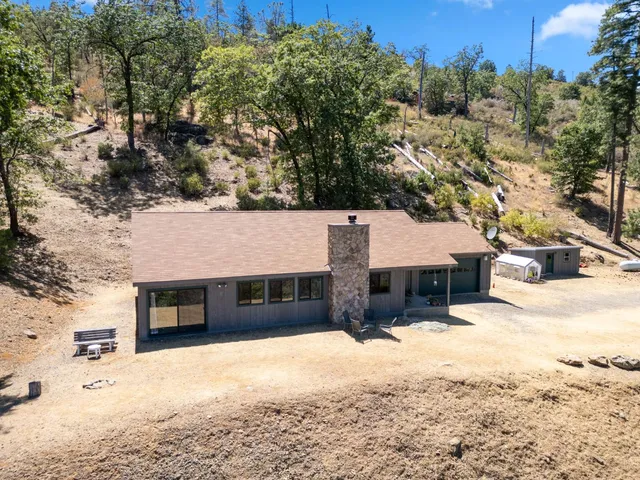 a front view of a house with a yard covered in snow