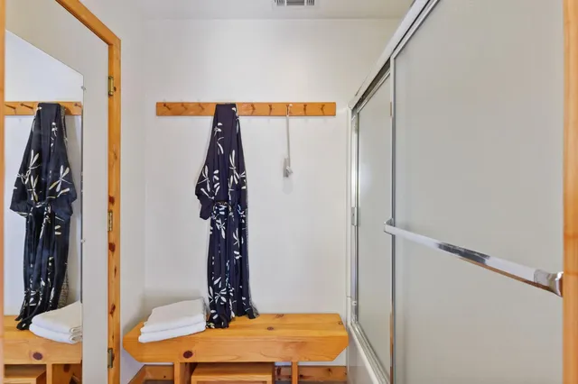 a front view of a house with a yard covered in snow