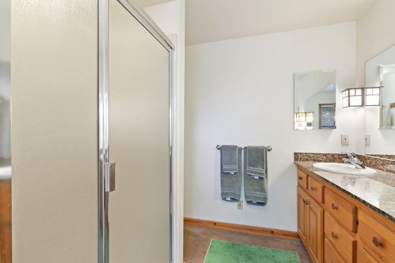 5851 Mt Bullion Ridge Road Mariposa, CA 95338 - Photo 37 of 83 a bathroom with a granite countertop sink and a mirror