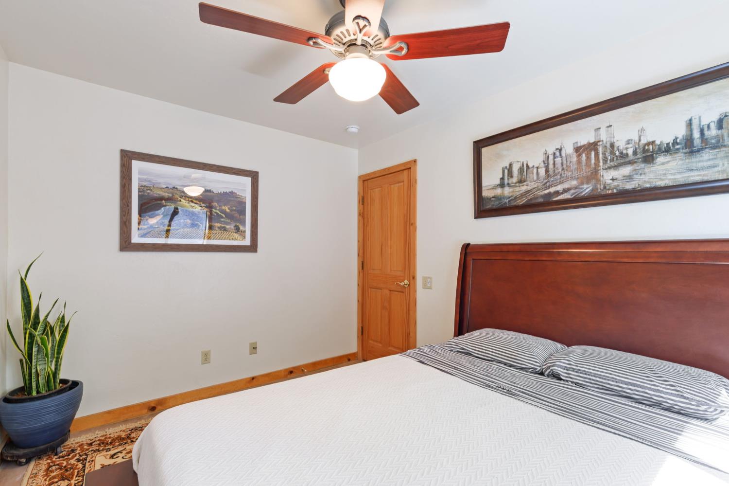 5851 Mt Bullion Ridge Road Mariposa, CA 95338 - Photo 40 of 83 a bedroom with a bed and a chandelier