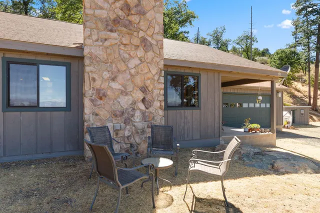 a view of a house with backyard and sitting area