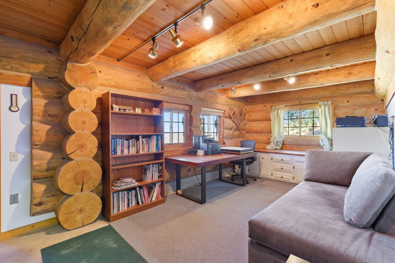 5851 Mt Bullion Ridge Road Mariposa, CA 95338 - Photo 60 of 83 a living room with furniture a bookshelf and a large window