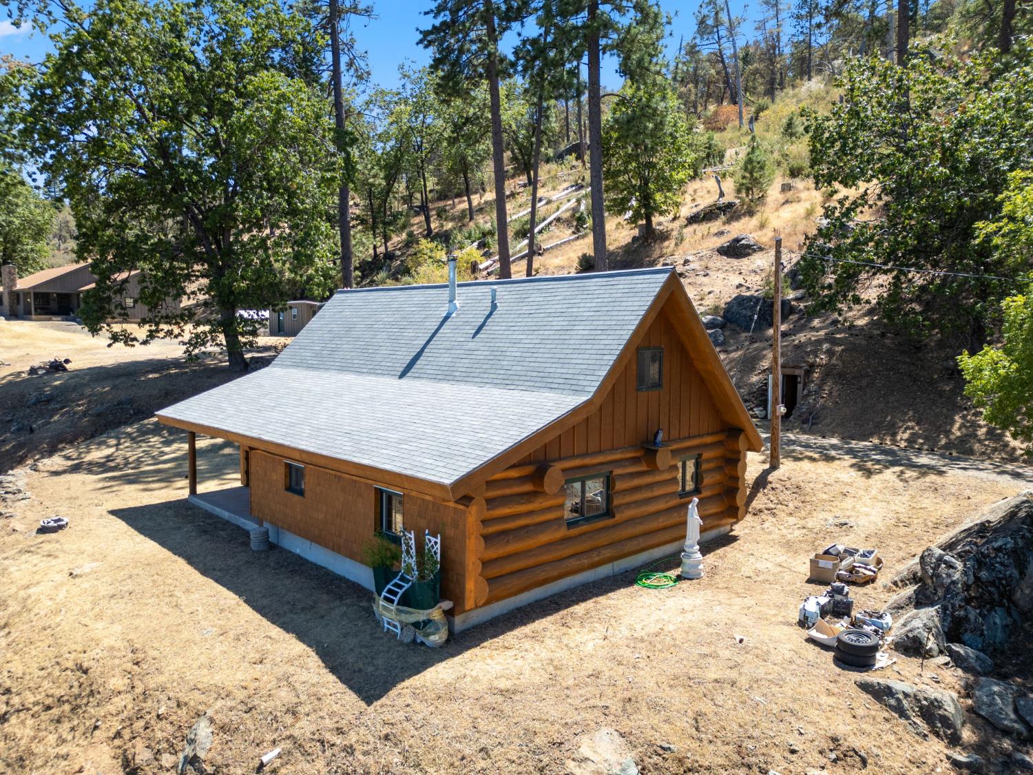 5851 Mt Bullion Ridge Road Mariposa, CA 95338 - Photo 76 of 83 a aerial view of a house with a yard covered with snow in the background